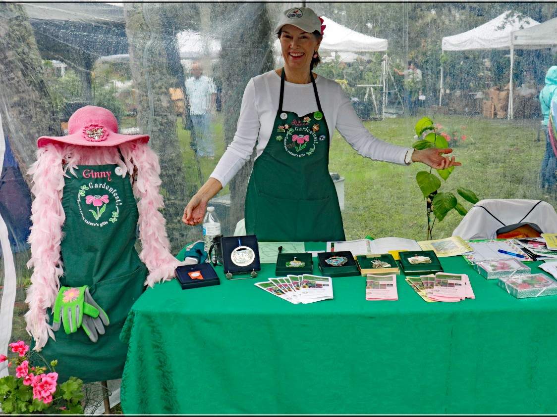 Woman in hat standing behind a table with green table cloth